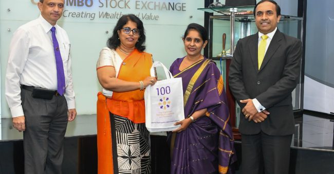 Gayani de Alwis giving gifts to members of the Colombo stock exchange during a visit